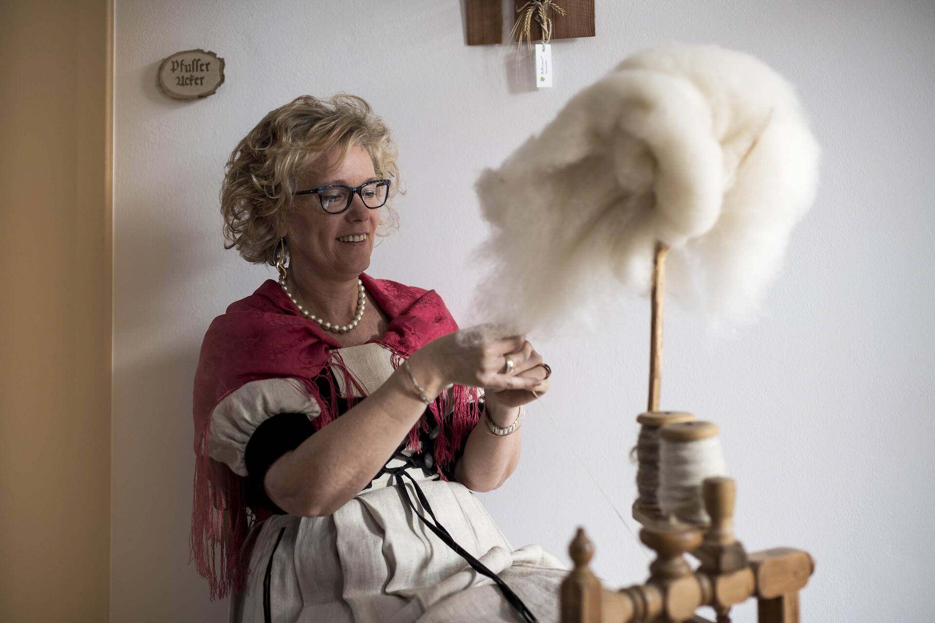 Woman in traditional costume spinning